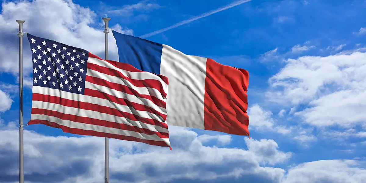 France and America waving flags on blue sky