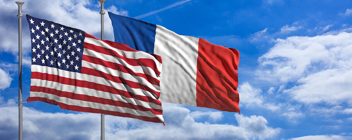 France and America waving flags on blue sky