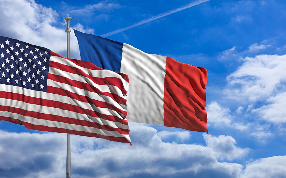 France and America waving flags on blue sky